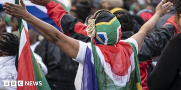 Protesters draped in South African flags in a rally against undocumented immigrants during a nationwide anti-immigration shutdown in Cape Town, South Africa, 30 June 2026.