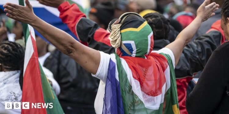 Protesters draped in South African flags in a rally against undocumented immigrants during a nationwide anti-immigration shutdown in Cape Town, South Africa, 30 June 2026.