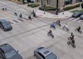 image shows e-bikers in an intersection