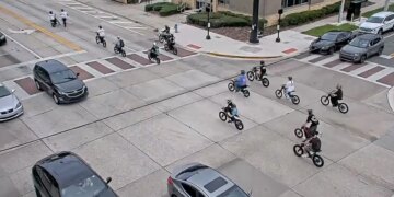 image shows e-bikers in an intersection