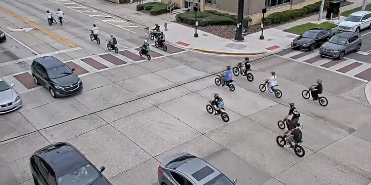 image shows e-bikers in an intersection