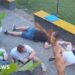 At least six people crouched on the floor as they take shelter from attack neaby
