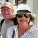 Karen Carter, pictured with her husband Alan. She is wearing dark glasses, a black and white sun hat and a white and striped shirt.