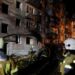 Firefighters work at the site of an apartment building hit by a Russian missile strike in Kyiv