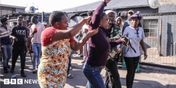 A woman, allegedly an undocumented migrant, is confronted as protesters search for foreign nationals during an anti-migrant march in Alexandra on 9 July 2026.