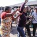 A woman, allegedly an undocumented migrant, is confronted as protesters search for foreign nationals during an anti-migrant march in Alexandra on 9 July 2026.