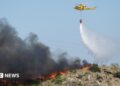 A helicopter works to extinguish flames amid deadly wildfires affecting Almeria province