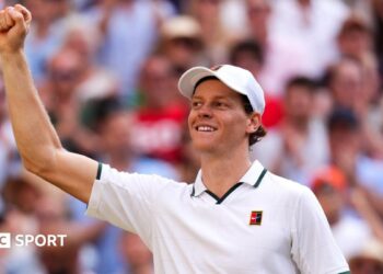 Jannik Sinner celebrates his victory over Novak Djokovic on Centre Court