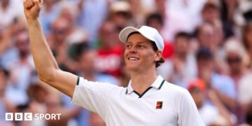 Jannik Sinner celebrates his victory over Novak Djokovic on Centre Court