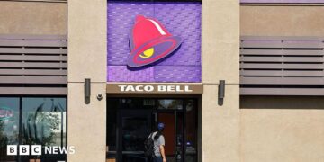 A person enters a Taco Bell restaurant on July 14, 2026 in Pasadena, California.