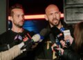 Andrew Tate talks to the media outside his residence in Bucharest, Romania.