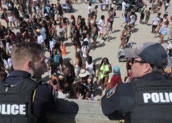 Police overlook a crowd at Orange Crush on Tybee Island on Saturday, April 19.