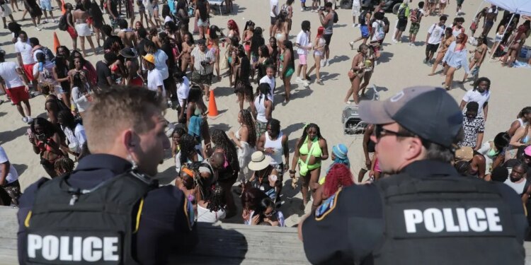 Police overlook a crowd at Orange Crush on Tybee Island on Saturday, April 19.