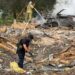 Emergency services clear through the rubble following a Russian missile strike just outside of Kyiv. Firefighters can be seen extinguishing a car fire in the background
