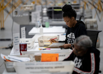 Fulton county workers process absentee ballots at ahead of the U.S, presidential election, in Atlanta