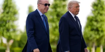 President Donald Trump poses with Turkish President Recep Tayyip Erdoğan ahead of the NATO summit.