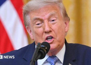 Donald Trump speaking at a podium on 16 July