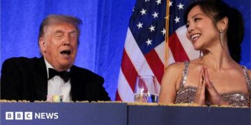 Trump reacts next to CBS News senior White House correspondent and White House Correspondents' Association President (WHCA) Weijia Jiang at the WHCA Dinner