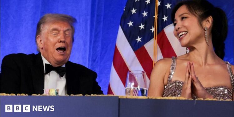 Trump reacts next to CBS News senior White House correspondent and White House Correspondents' Association President (WHCA) Weijia Jiang at the WHCA Dinner