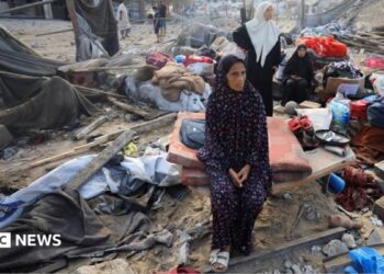 Palestinians inspect the site of Wednesday's Israeli strike on a house whose residents were pre-warned by the Israeli military to evacuate, in Gaza City
