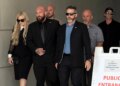 Erika Kirk, left, wearing a black dress and sunglasses as she leaves the Fourth District Courthouse in Provo