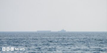 Vessels float in the Strait of Hormuz.