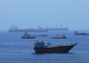 A view of commercial cargo vessels and crude oil tankers are anchored in the Gulf of Oman, off the coast of Muscat, Oman, on June 21, 2026, as they prepare to transit through the critical Strait of Hormuz