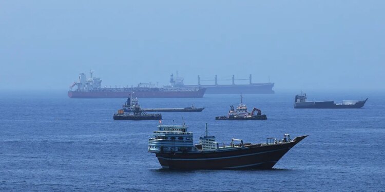 A view of commercial cargo vessels and crude oil tankers are anchored in the Gulf of Oman, off the coast of Muscat, Oman, on June 21, 2026, as they prepare to transit through the critical Strait of Hormuz