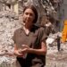 Sarah Rainsford standing in front of rubble
