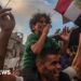 Boy sits on his father's shoulders
