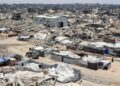 A landscape shows sheer destruction across Gaza. Rubble, dust and dirt.