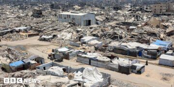 A landscape shows sheer destruction across Gaza. Rubble, dust and dirt.