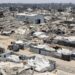 A landscape shows sheer destruction across Gaza. Rubble, dust and dirt.