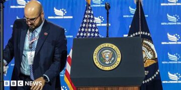 White House teleprompter operator Gabriel Perez sets up a teleprompter before US President Donald Trump speaks at the Faith & Freedom Coalition's 2026 Policy Conference at the Washington Hilton in June.