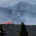 A firefighting plane drops fire retardant as it flies over a wildfire in Ille-sur-Tet near Perpignan in southern France.