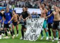 The Argentina players celebrate at full-time with a banner that reads "The Falkland Islands are Argentinian" during the World Cup 2026 semi-final between England and Argentina