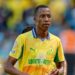 Footballer Divine Lunga is seen during a match in a yellow and green Mamelodi Sundowns shirt