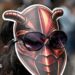 A woman wearing a cockroach mask on the back of her head