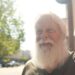 David Carter sports a full white beard - which helps him play Santa at Christmas - as he stands on a main street in downtown Kingstport