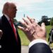 Trump talking to reporters whil holding finger up to camera