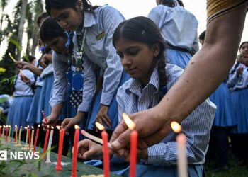 Mourners and students light candles to offer their condolences after the death of mountaineer Nirmal Purja