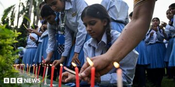 Mourners and students light candles to offer their condolences after the death of mountaineer Nirmal Purja