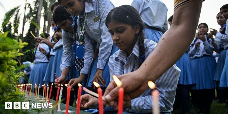 Mourners and students light candles to offer their condolences after the death of mountaineer Nirmal Purja