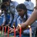 Mourners and students light candles to offer their condolences after the death of mountaineer Nirmal Purja
