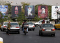 Banners with pictures of the late Supreme Leader of Iran, Ayatollah Ali Khamenei, are displayed on a street in Tehran