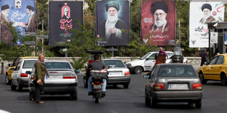 Banners with pictures of the late Supreme Leader of Iran, Ayatollah Ali Khamenei, are displayed on a street in Tehran