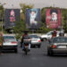 Banners with pictures of the late Supreme Leader of Iran, Ayatollah Ali Khamenei, are displayed on a street in Tehran