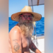 Donald Steven Lang aboard a sailboat wearing a straw hat