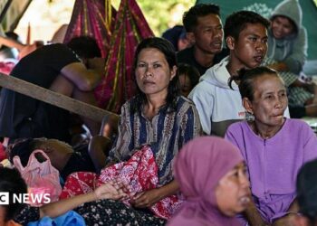 Villagers rest in a tent in an open field in East Nusa Tenggara