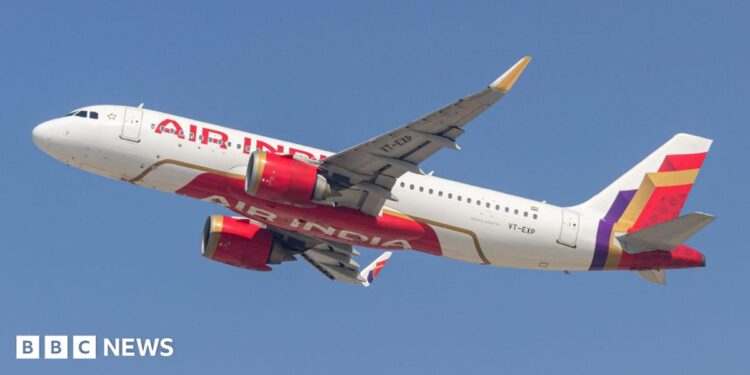 An Air India plane - white with red lettering and a red, gold and purple pattern at the tail - flying against a blue sky